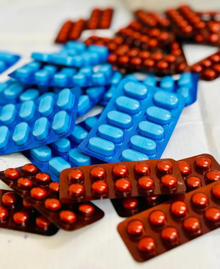 Blue and red tablet strips stacked on a counter