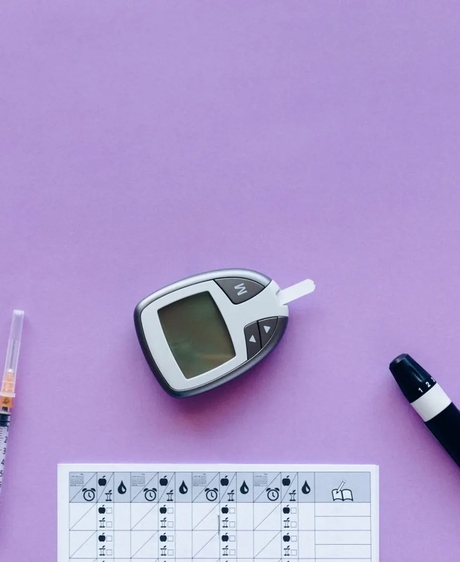A glucometer, syringes and a sugar chart