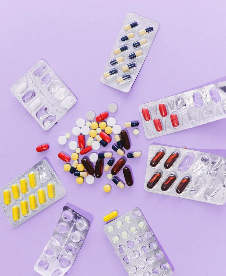 Tablets and capsules laid out beside their strips